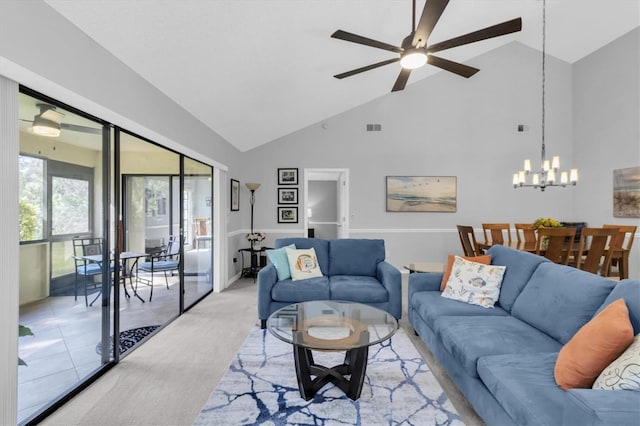 tiled living room with ceiling fan with notable chandelier and high vaulted ceiling