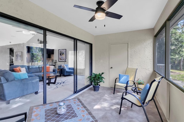 sunroom / solarium featuring a wealth of natural light and ceiling fan