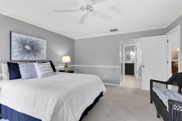 carpeted bedroom featuring crown molding, ensuite bathroom, and ceiling fan