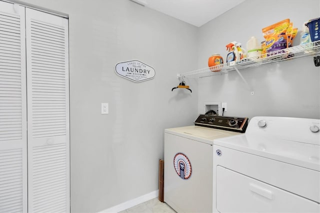 clothes washing area with washing machine and clothes dryer