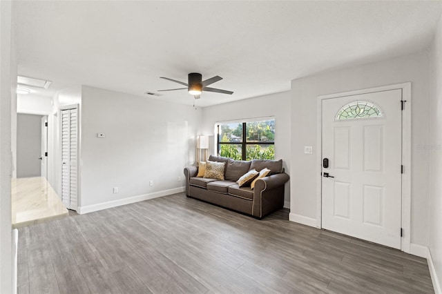 living room with hardwood / wood-style flooring and ceiling fan