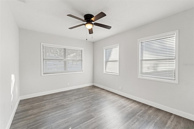 empty room with ceiling fan and hardwood / wood-style floors