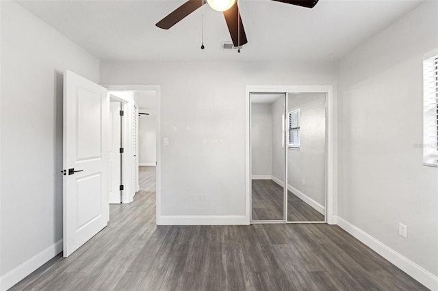 unfurnished bedroom featuring hardwood / wood-style flooring, ceiling fan, and a closet