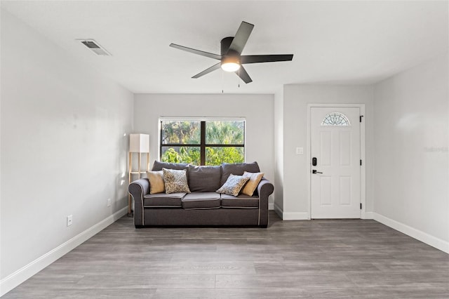 living room with ceiling fan and light wood-type flooring