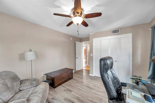 office space featuring ceiling fan and light hardwood / wood-style flooring