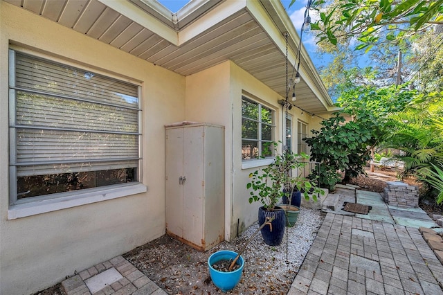 view of exterior entry featuring a patio area