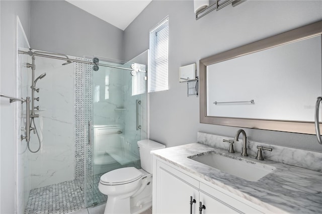 bathroom with walk in shower, vanity, and toilet