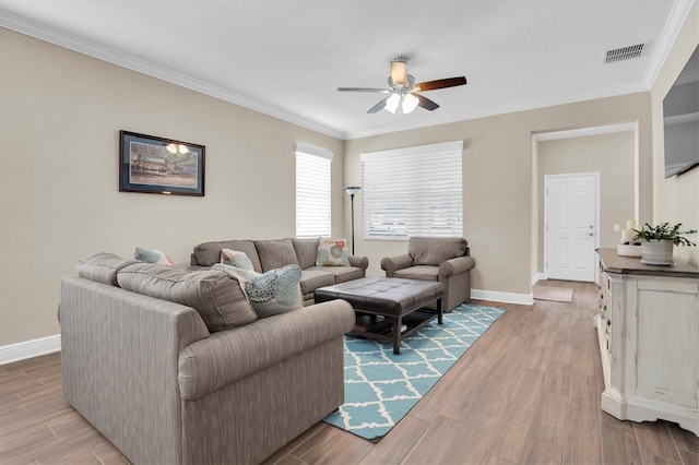 living room with ceiling fan, ornamental molding, and light hardwood / wood-style flooring