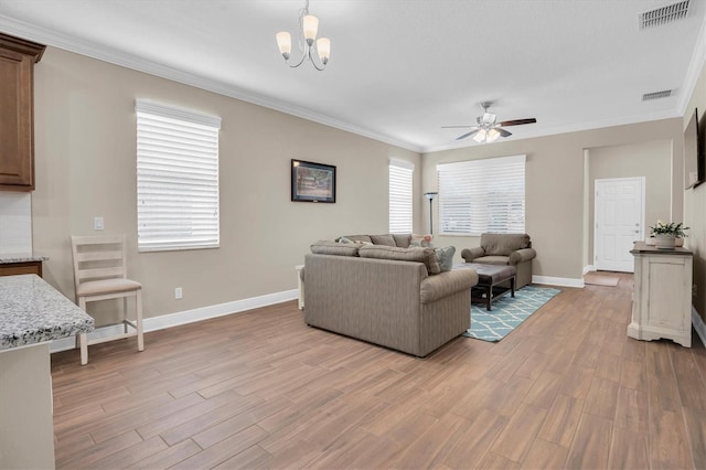 living room featuring ornamental molding, ceiling fan with notable chandelier, and light hardwood / wood-style floors