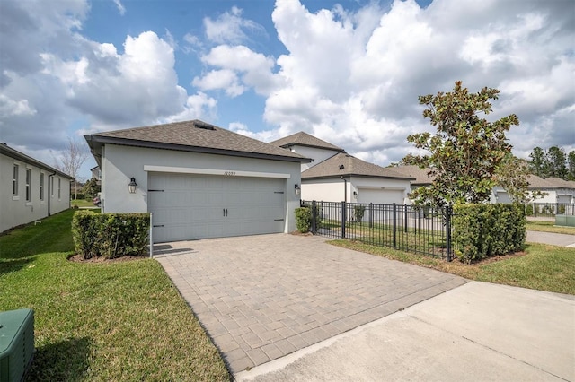 view of front of house featuring a garage and a front lawn