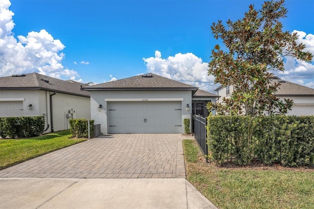 view of front of home with a garage and a front yard