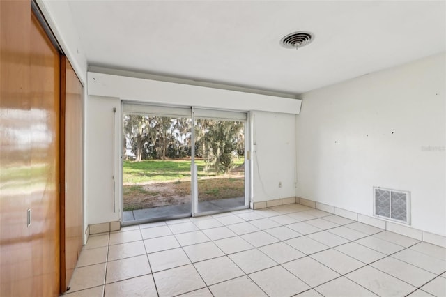 unfurnished room with light tile patterned floors