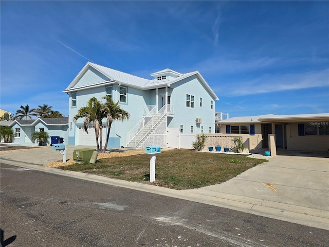 view of front of house with a front yard and a carport