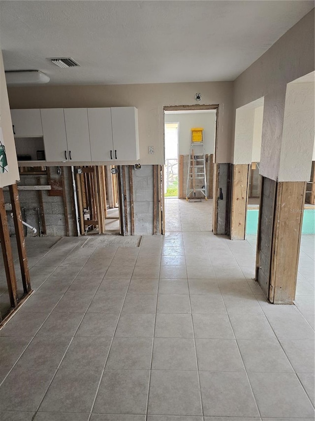 hall with light tile patterned flooring