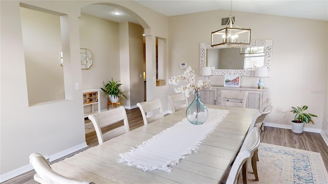 dining space with lofted ceiling and light hardwood / wood-style floors