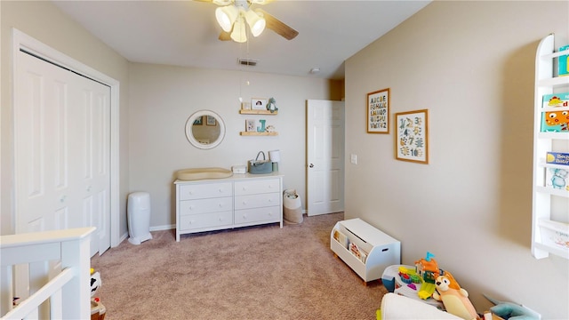 bedroom with ceiling fan, a closet, and light carpet