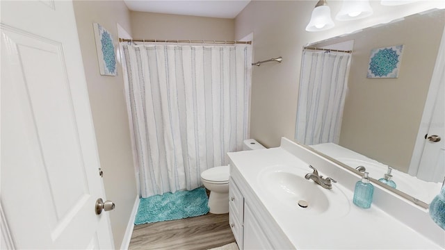 bathroom featuring vanity, toilet, a shower with shower curtain, and wood-type flooring