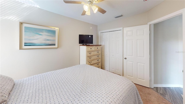 bedroom featuring a closet, ceiling fan, and carpet flooring