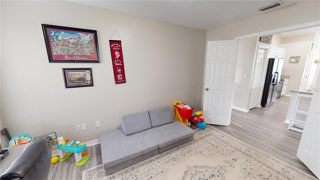 recreation room with light hardwood / wood-style floors