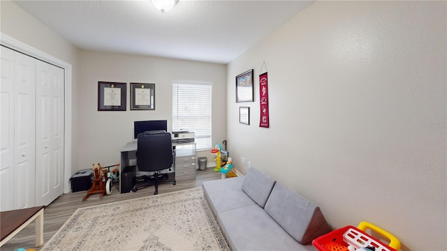 home office with light hardwood / wood-style floors