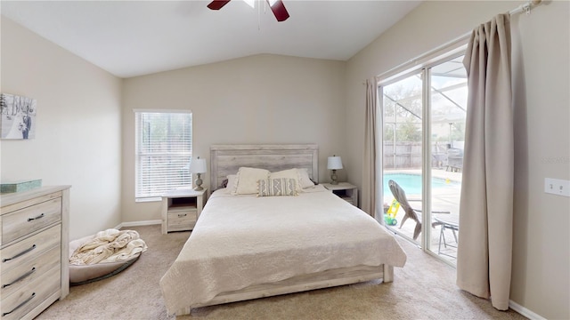 carpeted bedroom featuring vaulted ceiling, access to exterior, and ceiling fan