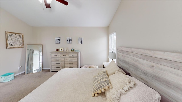 bedroom with ceiling fan, vaulted ceiling, and carpet