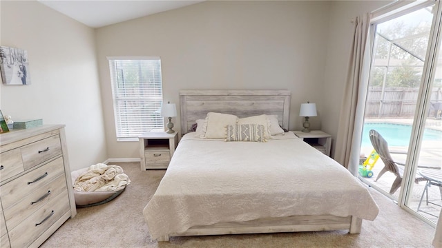 carpeted bedroom featuring vaulted ceiling and access to outside