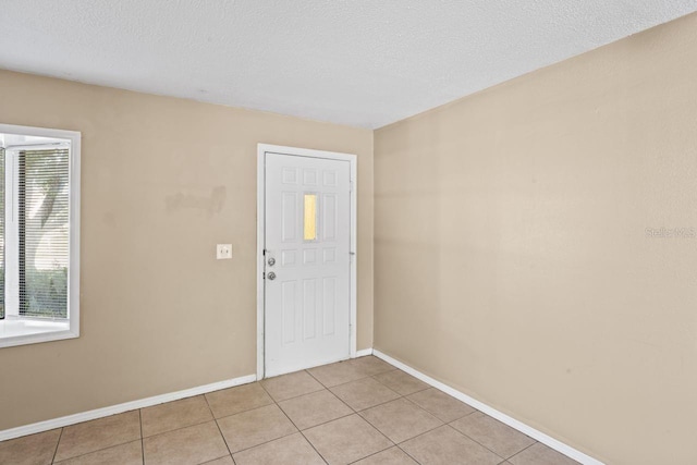 tiled entrance foyer with a textured ceiling