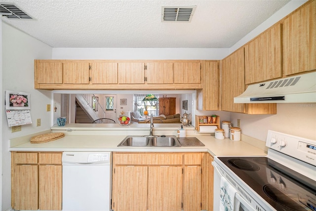 kitchen featuring light brown cabinetry, sink, a textured ceiling, white appliances, and range hood