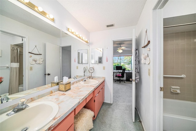 bathroom featuring vanity, a textured ceiling, and shower / bathtub combination with curtain