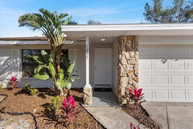 view of exterior entry featuring a garage