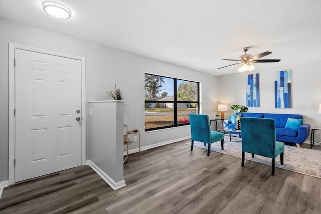 foyer featuring ceiling fan, dark wood-type flooring, and a textured ceiling