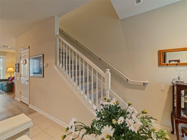 staircase featuring tile patterned floors