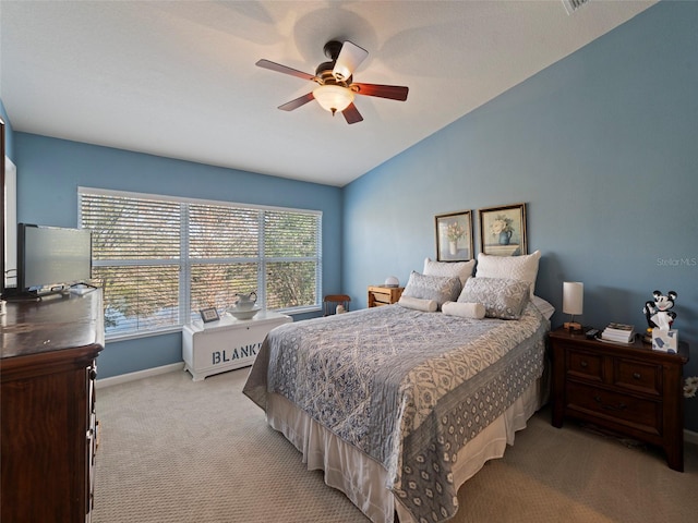 carpeted bedroom featuring vaulted ceiling and ceiling fan