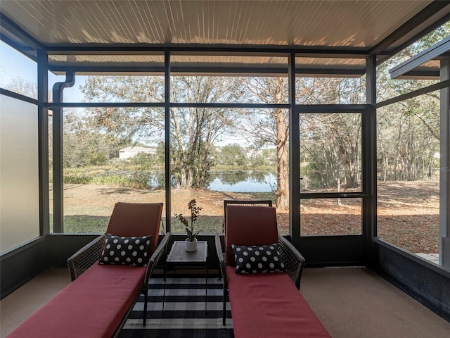 sunroom / solarium featuring a water view