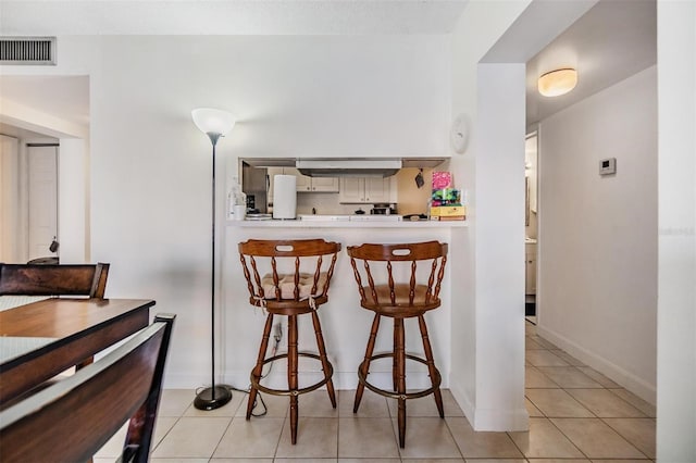 kitchen with light tile patterned floors and decorative backsplash