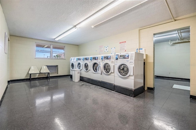 laundry area featuring washer and dryer and a textured ceiling