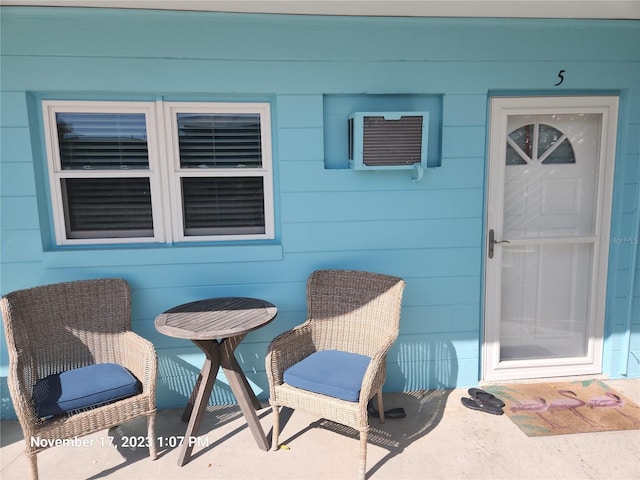 doorway to property with a wall mounted AC