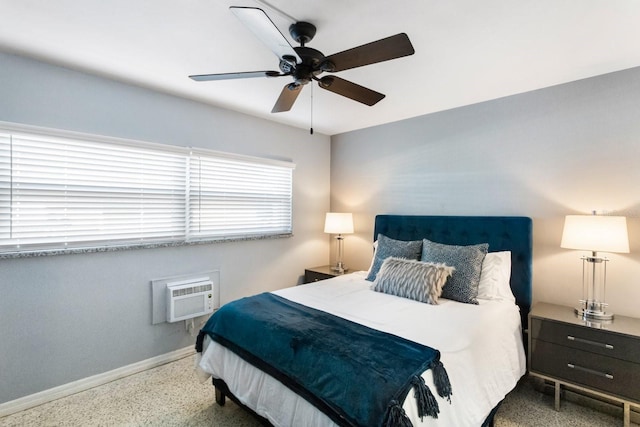 bedroom featuring ceiling fan and an AC wall unit