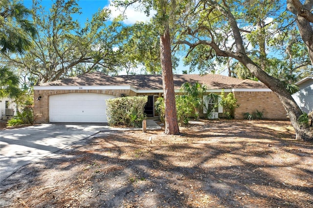 ranch-style house featuring central AC and a garage