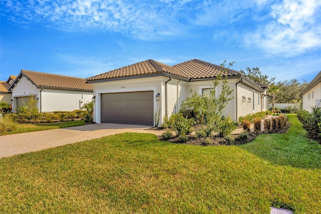 mediterranean / spanish-style house featuring a garage and a front yard