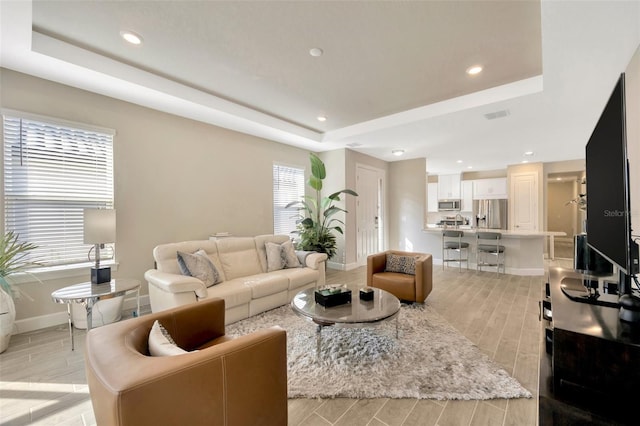 living room featuring a tray ceiling