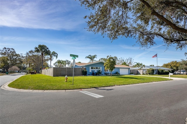 ranch-style home with a garage and a front yard