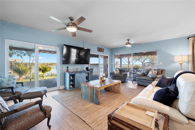 living room with hardwood / wood-style floors and ceiling fan