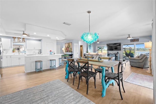 dining space featuring ceiling fan and light wood-type flooring