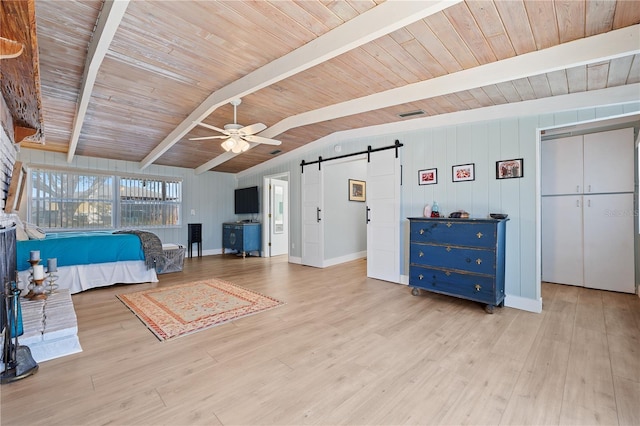 bedroom with ceiling fan, vaulted ceiling with beams, light hardwood / wood-style floors, wooden ceiling, and a barn door