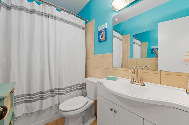 full bathroom featuring vanity, tile walls, shower / tub combo with curtain, and toilet