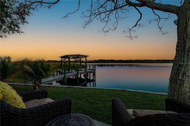 view of dock featuring a water view and a lawn