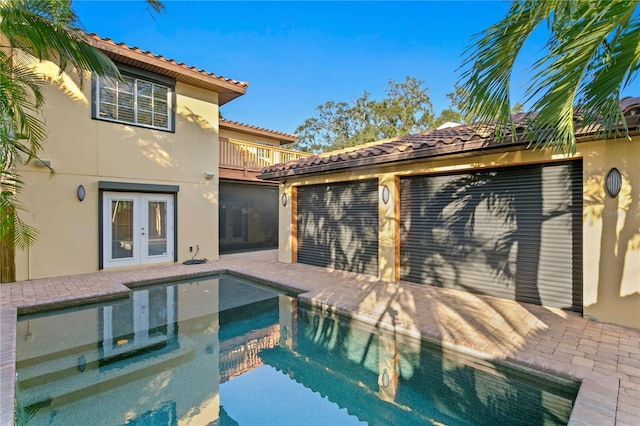 view of swimming pool featuring french doors and a patio area