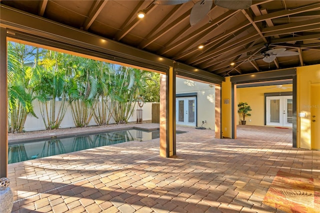 view of patio / terrace featuring a fenced in pool, french doors, and ceiling fan